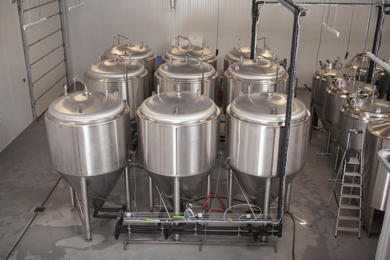 Metal beer tanks at beer factory, copy space